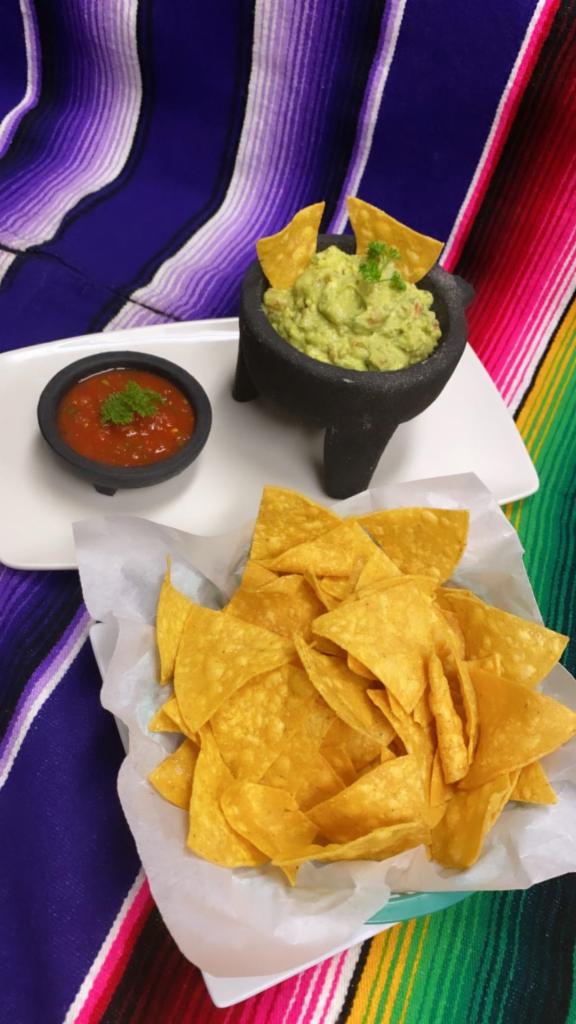 Guacamole and chips · Our homemade salsa and guac(avocado, onions, cilantro, tomatoes, jalapenos, a pinch of salt, and a dash of lime) served with corn tortilla chips - perfect for dipping. 