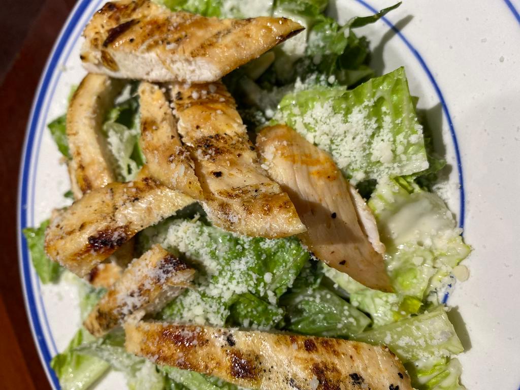 Chicken Caesar Salad  · grilled chicken, romaine lettuce, Parmesan cheese, and croutons tossed in Caesar dressing
