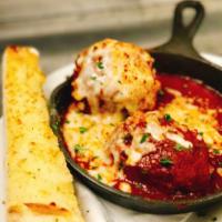 The Balls · Two of our homemade meatballs soaked in marinara and topped with Parmesan, Mozzarella and Ro...