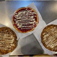 Cherry Pizza Pie · Traditional pizza crust with Cherry pie filling topped with vanillia icing.  Available in sa...