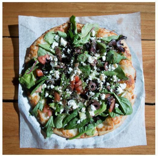 The Greek Pizza Salad · Mixed greens, cucumber, tomato, kalamata olives, with balsamic dressing, and oregano, on top of a cheese pizza with red onions.