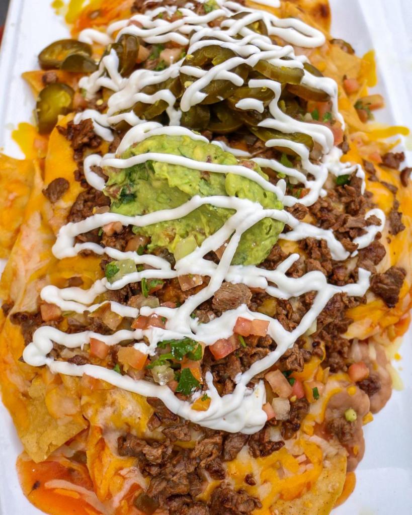 Cabrera's Nachos · Traditional nachos covered with beans and melted cheese topped with guacamole, pico de gallo, jalapenos and sour cream.
