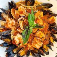Aqua Pazza · Shrimp, clams & mussels in a filetto sauce over linguine.