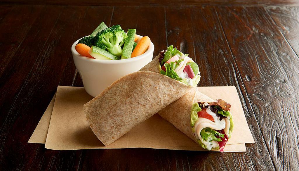 Turkey Wrap · Roasted turkey breast, Roma tomatoes, organic field greens, guacamole, ranch dressing, toasted organic wheat wrap. Served with 1 side: fresh fruit, steamed veggies, baked chips or blue corn chips with salsa.