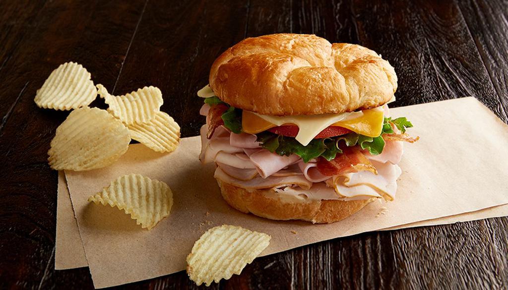 Club Royale · Nitrite-free smoked turkey breast and ham, bacon, Swiss, cheddar, leafy lettuce, tomato, honey mustard and toasted croissant.