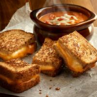 Grilled Cheese and Tomato Soup Combo · It's back! Grilled Muenster and cheddar cheese sandwich on multigrain wheat, bowl of tomato ...