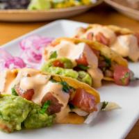 Ahi Tuna Tacos · Three crisp sushi grade tuna tacos, jicama, ginger slaw, guacamole, pickled red onion, and c...
