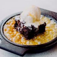 Tres Chocolate Brownie · With walnuts, Mexican brandy butter, and vanilla ice cream.