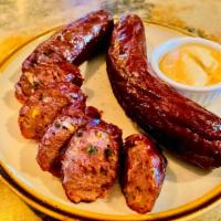 Two Wagyu Sausages · 100% Wagyu beef stuffed with jalapeño & cheddar cheese. Served with side of Dijon mustard.