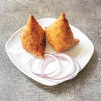 Lamb Samosa · Ground lamb and peas, mildly spiced and stuffed in a light pastry.
