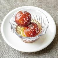 Gulab Jamun · Soft deep fried milk and cheese dumplings dipped in honey syrup.