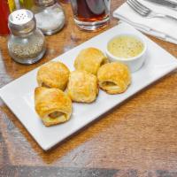 Pigs in a Blanket · Housemade fennel sausage and puff pastry.