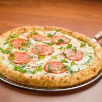 Margherita Pizza · Mozzarella, tomatoes, garlic and sprinkled with fresh basil.