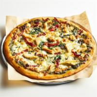 Nat Pizza · Basil pesto with sundried tomatoes, topped with a mixture of mozzarella and feta cheese, spi...