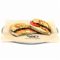 Pesto Turkey Panini · Fresh basil pesto with spinach, Roma tomatoes, and hand-carved turkey breast, topped with sl...