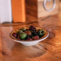 *Mixed Olives · Green and black olives infused with red peppers and a hint of chili. Vegetarian.