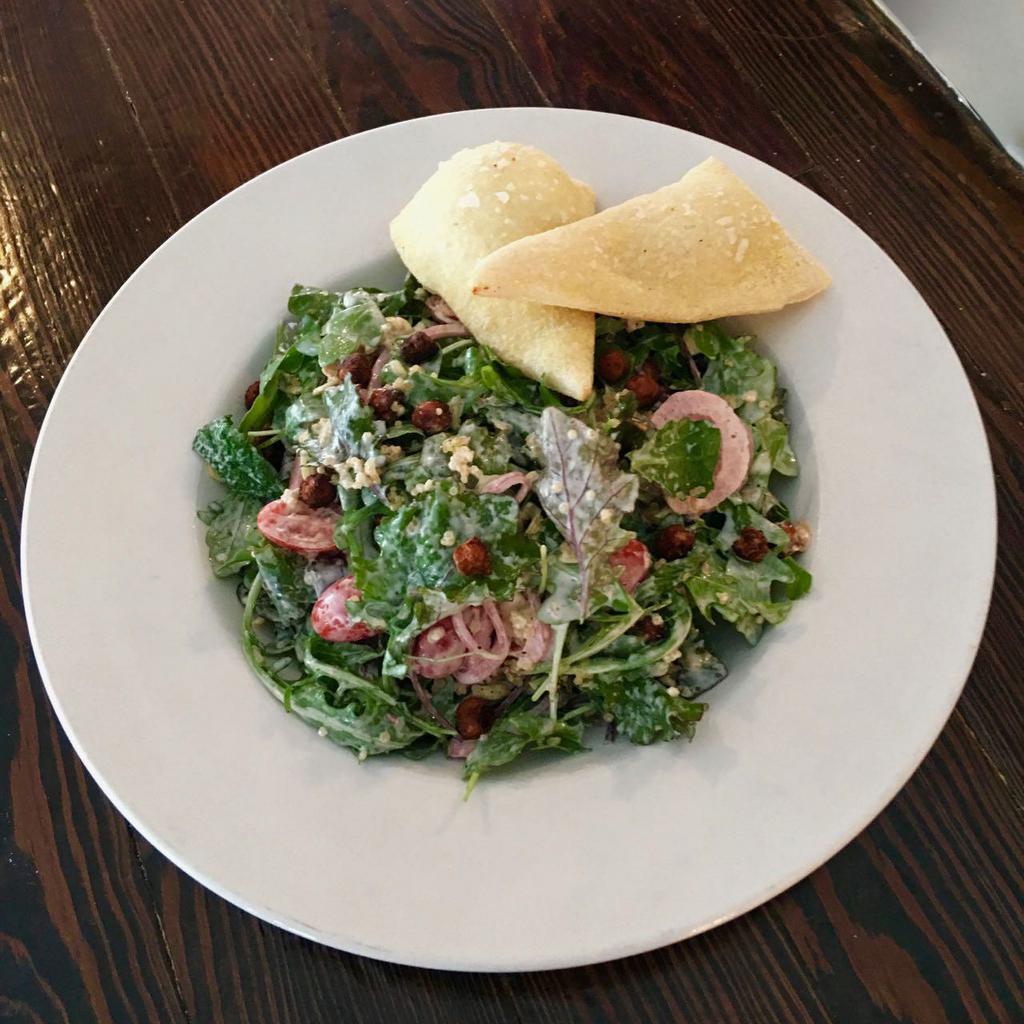 Kale Salad · Baby kale, baby arugula, quinoa, toasted chickpeas, pickled red onion, almonds, tomato, buttermilk dressing, and cornmeal flatbread.