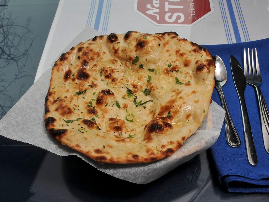 Garlic Naan · Naan topped with garlic and butter.