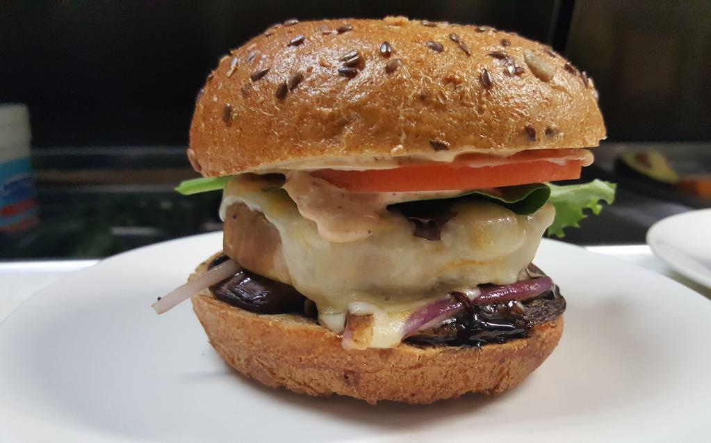 Portobello Eggplant Melt Burger · Pile high grilled mushroom, eggplant, onion, bast of balsamic glaze and melted Muenster cheese.