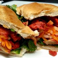 VEGAN CHAR SIU BANH MI (NEW) · Thinly-sliced juicy soy protein marinated in our special char siu BBQ sauce served with daik...