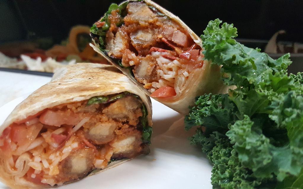 Blue Cheese Buffalo Soy chicken Wrap · Crispy soy chicken, mild buffalo sauce, cool blue cheese dressing, lettuce, tomato and soy bacon in wheat flour tortilla. Served with corn chips.
