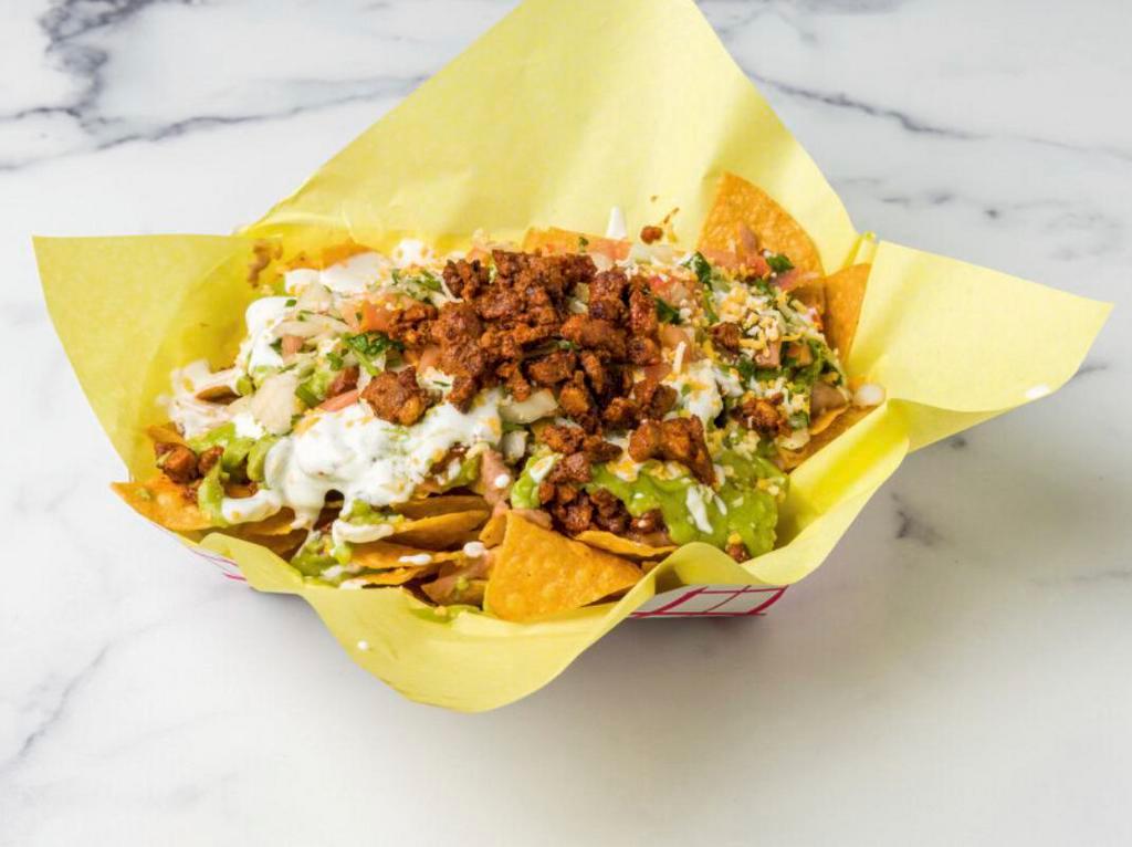 Super Nachos · served with your choice of meat, beans, sour cream, guacamole, pico de gallo and cheese