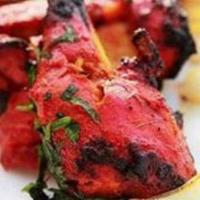Chicken Tandoori · Chicken marinated in yogurt, blended with ginger, garlic, herbs and spices then grilled in a...