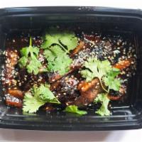 Szechuan Eggplant · -Side Steamed Rice
-Chili oil, sweet soy glaze, scallions, sesame seeds