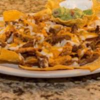 Nachos Santa Fe · Grilled chicken and steak over corn chips and beans, covered with mozzarella cheese and jack...
