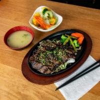 Kalbi · Grilled marinated beef short ribs, steamed vegetables and sesame see. Served with small mio ...