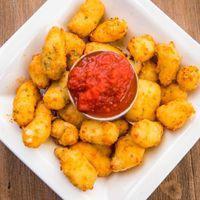 Gilroy Garlic Cheese Curds · Breaded garlic cheese curds served with a side of our in-house marinara sauce