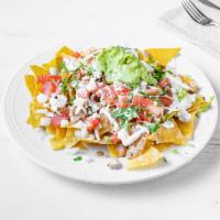 Chicken Nachos · Fried tortillas chips topped with beans, melted cheese, chicken, tomato, onion, jalapeños, s...