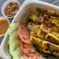 Chicken satay salad · Chicken satay with mixed green salad , cucumbers and tomatoes served with peanut sauce and c...