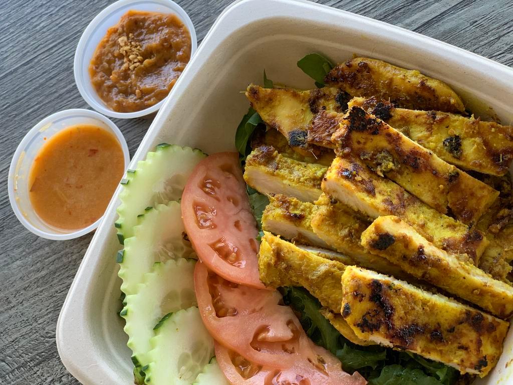 Chicken satay salad · Chicken satay with mixed green salad , cucumbers and tomatoes served with peanut sauce and chili peanut vinaigrette. Contain: nuts and sesame