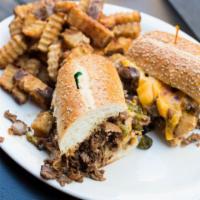 Philly Cheesesteak Sandwich · Shaved slow-roasted prime roast beef, smothered with sautéed onions and peppers, topped with...