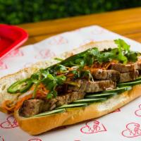Smoked Brisket Banh MI · 14 hour smoked  beef brisket on a baguette with house-made garlic aioli, pickled carrots, ci...