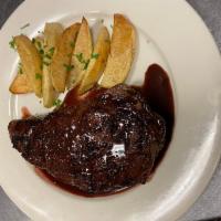 Costata di Manzo · Ribeye steak charcoal grilled and topped with port wine sauce, garnished with roasted potato...