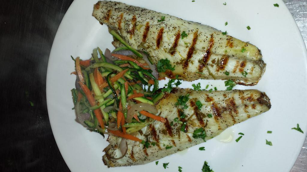 Branzino alla Griglia · Grilled and served with mixed vegetables and salmoriglio sauce.