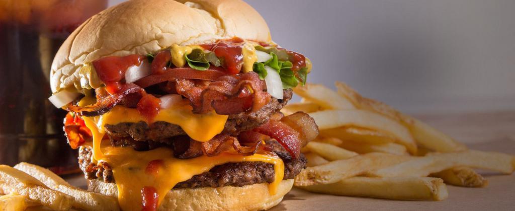 Double Bacon Burger · “Hold the bacon,” said no one ever. Our classic signature burger topped with four slices of crispy bacon for mouthwatering perfection.