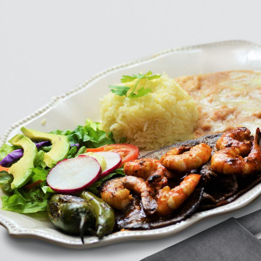 Mixed Plate House Special · Grilled juicy steak topped with tangy shrimp, served with rice, beans, salad, and hand-made tortillas.