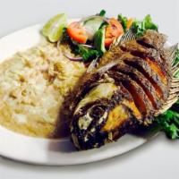 Tilapia Al Mojo De Ajo · Fried tilapia prepared in a garlic butter sauce. Served with rice, beans, and salad.