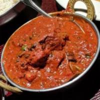 Chicken Rogan Josh · Chicken in onion based curry sauce simmered with fresh tomatoes, cilantro, garlic and ginger...
