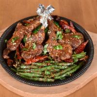 36. Cumin Lamb Chop · Four tender lamb chops marinated and seasoned with Szechuan spices and cumin. Served with st...