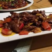 54. Black Pepper Beef · Sliced beef seasoned with black pepper and a homemade Worcestershire sauce, served with onio...