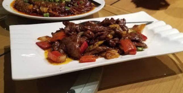 54. Black Pepper Beef · Sliced beef seasoned with black pepper and a homemade Worcestershire sauce, served with onions and red bell peppers
