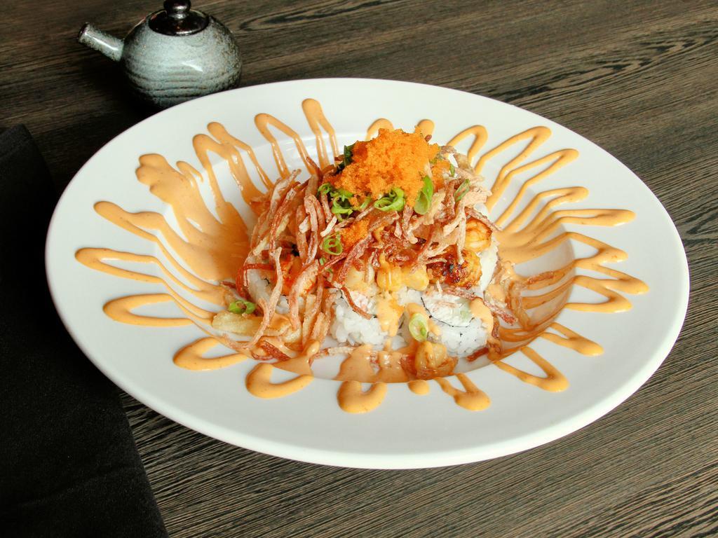 Volcano Roll · Cooked. California roll, baked spicy seafoods, tempura kani, masago, scallion, sesame seeds and spicy mayo.