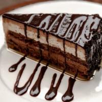 Chocolate Temptation Cake · Chocolate cake filled with chocolate & hazelnut creams, hazelnut crunch and chocolate glaze.