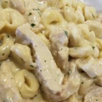 Alfredo Chicken · Covered with a rich creamy alfredo served with cheese tortellini.