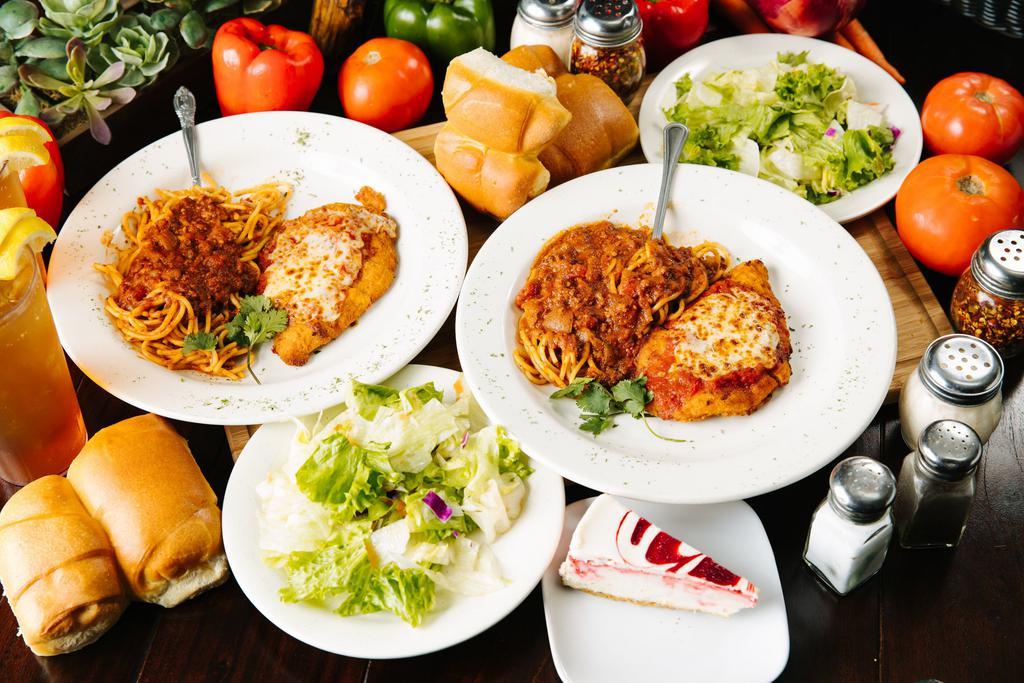 Chicken Parmigiana · Seasoned and lightly breaded chicken topped with marinara sauce, house-shredded mozzarella cheese, and a side of spaghetti. Served w/ tossed salad & bread. 

