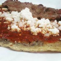 Tlacoyo con Salsa y Carne · Hand made tortilla stuffed with beans, topped with salsa, queso fresco, onions and option of...